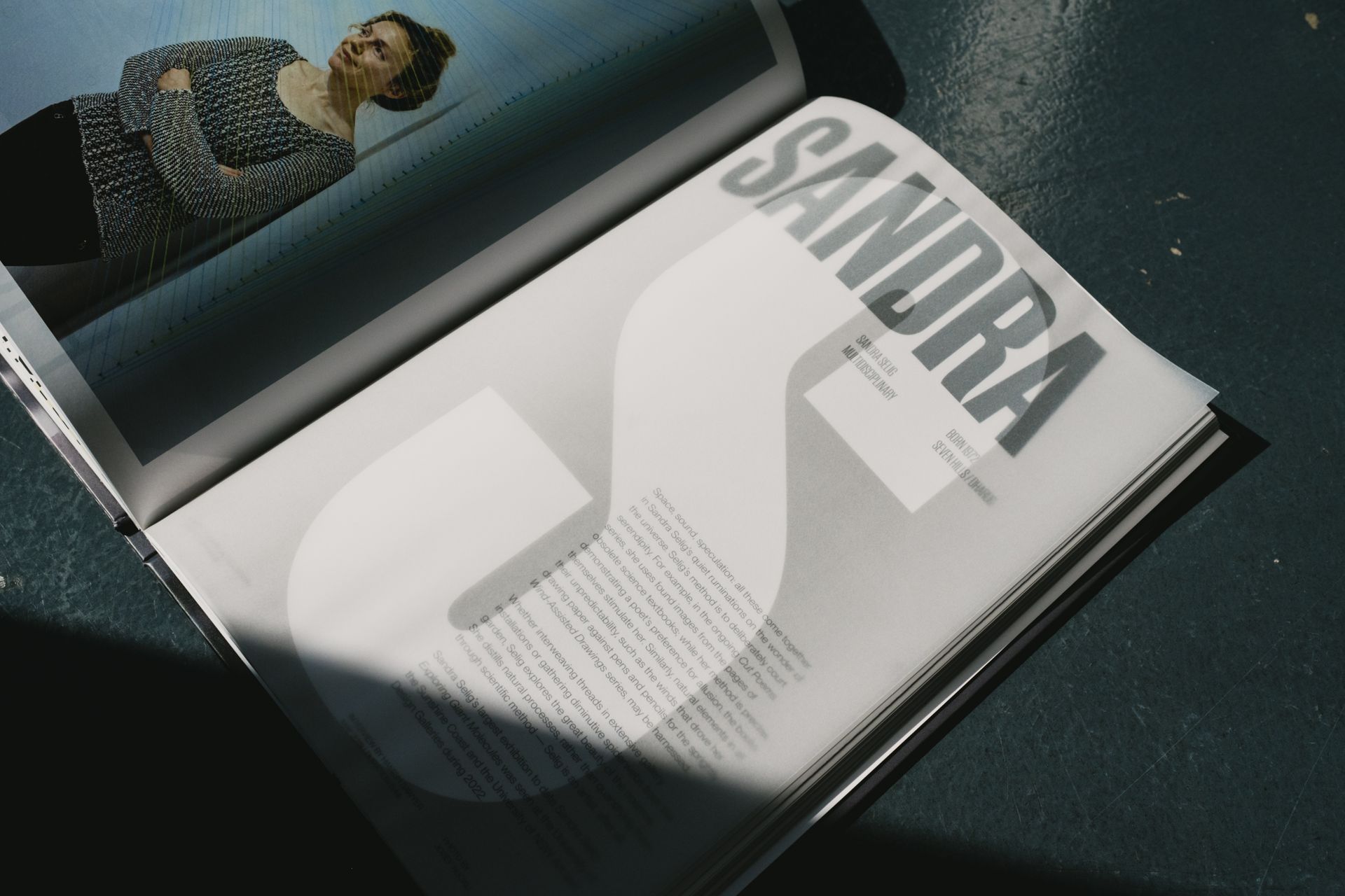 Internal spread designed for the Meet The Artists publication, featuring special printing techniques such as semi-transparent paper revealing the page beneath.